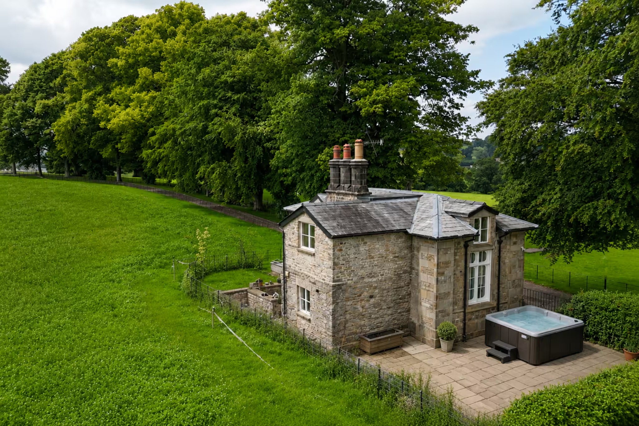 Summerfield Lodge surrounded by green countryside with its private hot tub